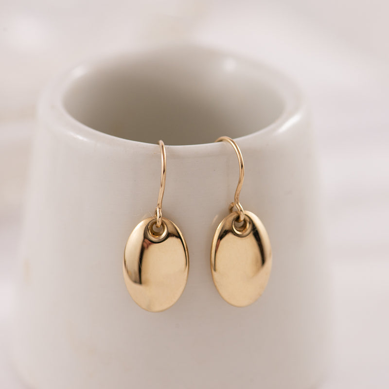 Gold pod earrings.