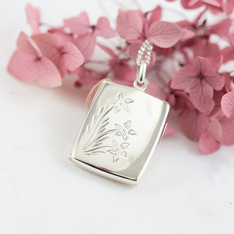 Silver rectangular locket with engraved flowers